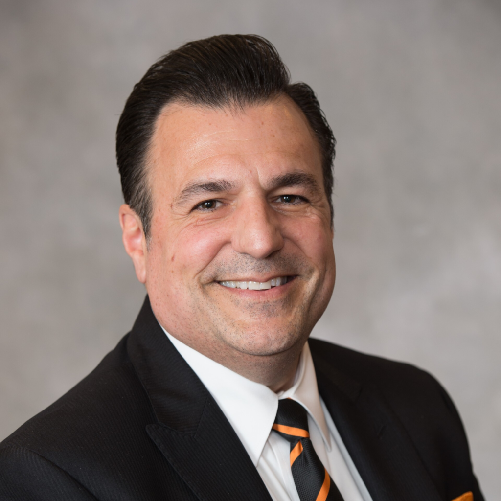 A man in a suit smiling. 